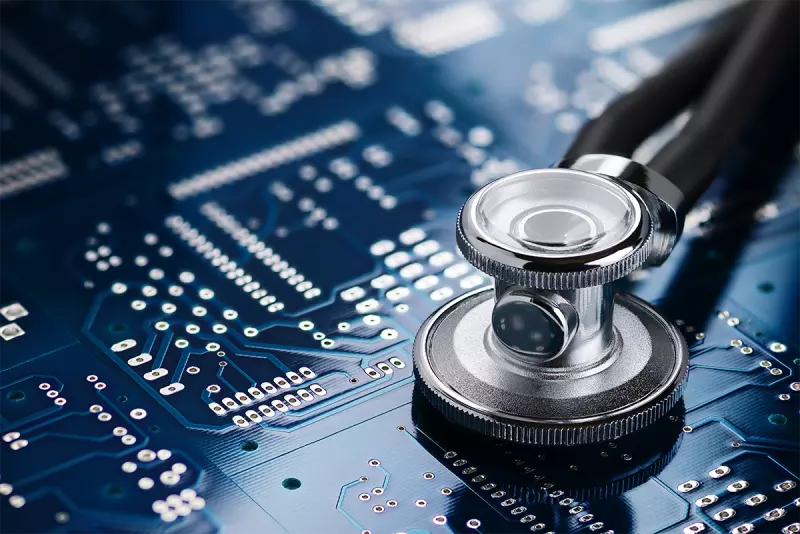 Medical stethoscope resting on a blue circuit board, symbolising healthcare technology and digital medicine.