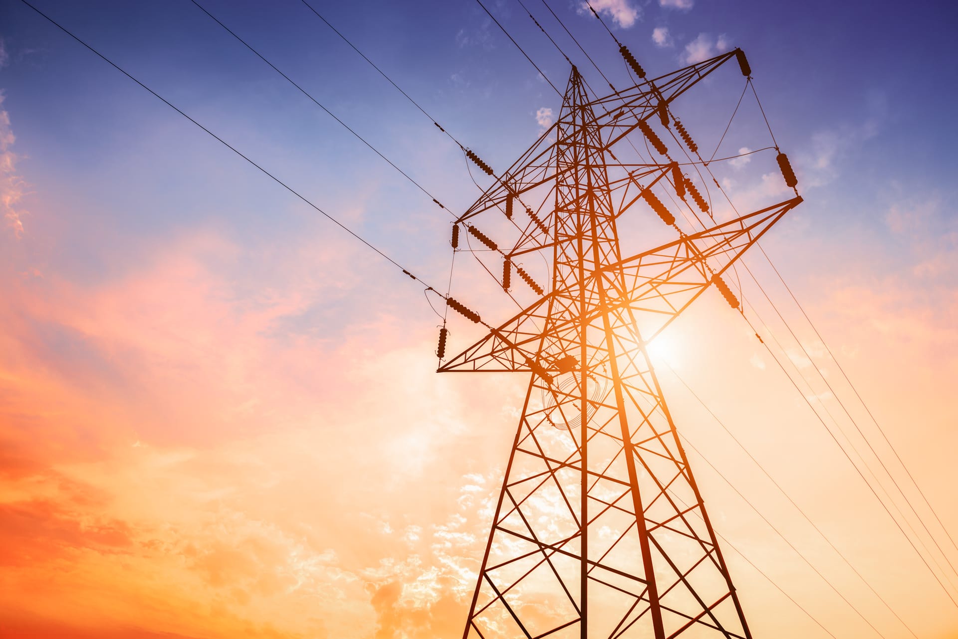 A transmission tower captured against the background of a colourful evening sky